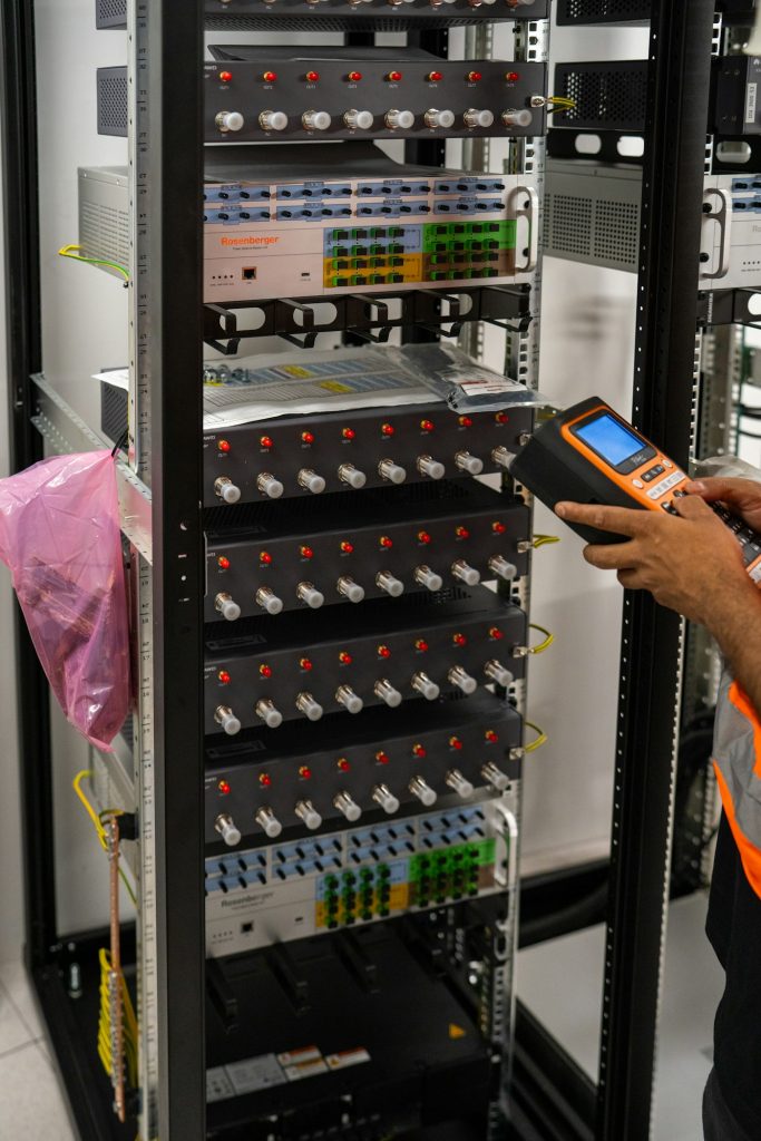 Technician checking server hardware for hosting uptime and backups